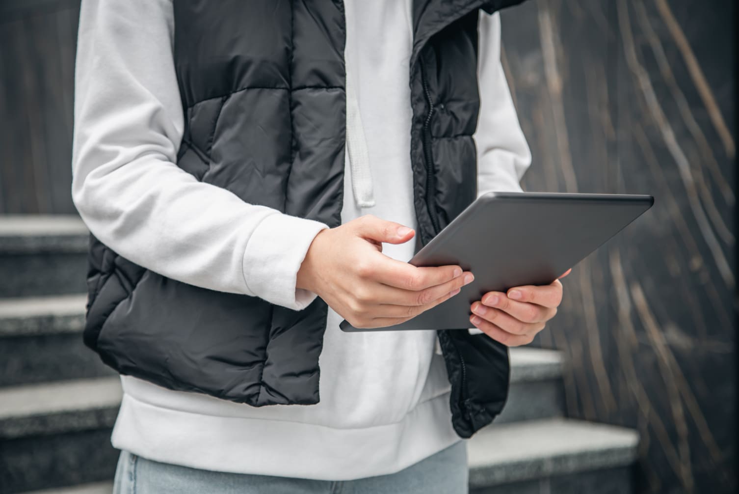 closeup woman is using tablet outside 1 1