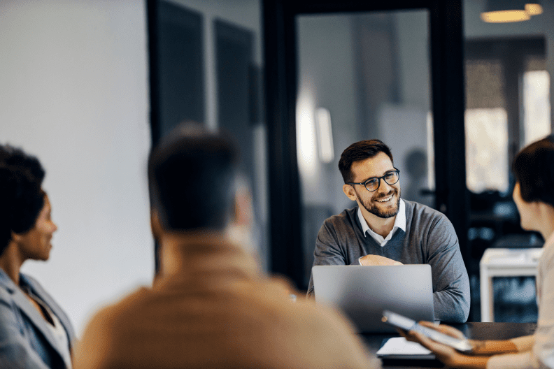 happy businessman is sitting co working space with colleagues having 2